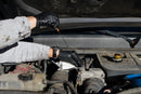 Mechanic wearing black nitrile gloves working in a car engine bay