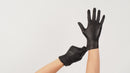 Bodyguards GL897 powder-free black nitrile glove held up against a plain background